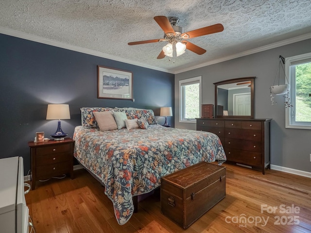 7376 NC-181 Hwy, Morganton, NC 28655 - bedroom featuring wood finished floors, crown molding, ceiling fan, and a textured ceiling
