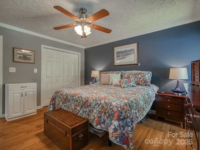 7376 NC-181 Hwy, Morganton, NC 28655 - bedroom with wood finished floors, a textured ceiling, a closet, ceiling fan, and ornamental molding
