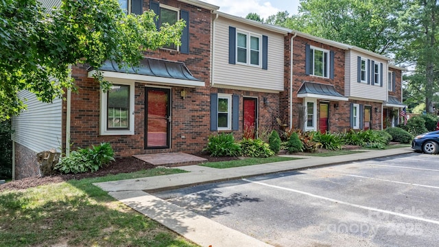 2705 N Center St Unit 76, Hickory, NC 28601 - multi unit property featuring uncovered parking, brick siding, a standing seam roof, and a metal roof