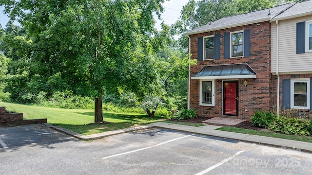 2705 N Center St Unit 76, Hickory, NC 28601 - view of front of home with brick siding, uncovered parking, and a front yard