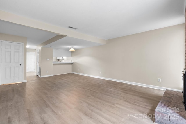 2705 N Center St Unit 76, Hickory, NC 28601 - unfurnished living room with baseboards and wood finished floors