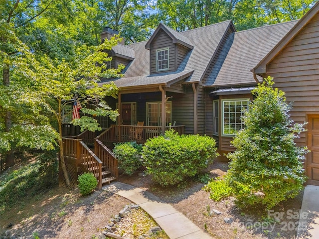 12 Woodvine Ln, Lake Wylie, SC 29710 - view of front of house featuring roof with shingles, a chimney, and a porch