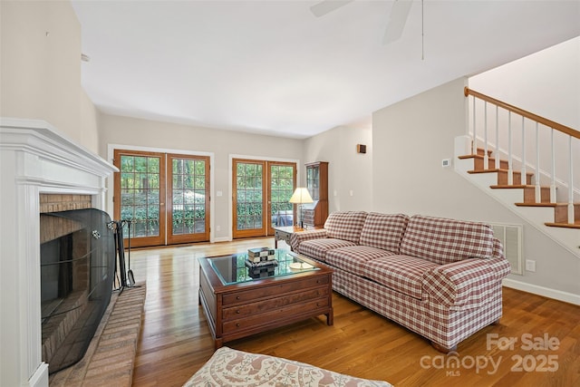 12 Woodvine Ln, Lake Wylie, SC 29710 - living area with wood finished floors, stairs, a brick fireplace, and a ceiling fan