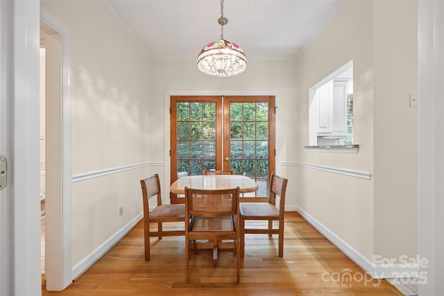 12 Woodvine Ln, Lake Wylie, SC 29710 - dining room with light wood-type flooring, a chandelier, and crown molding