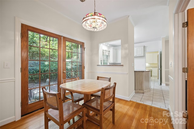 12 Woodvine Ln, Lake Wylie, SC 29710 - dining space featuring a chandelier, light wood finished floors, and crown molding