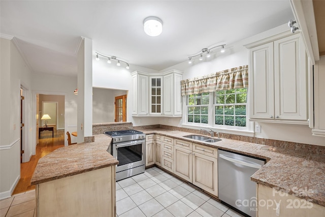 12 Woodvine Ln, Lake Wylie, SC 29710 - kitchen with appliances with stainless steel finishes, a peninsula, light tile patterned flooring, glass insert cabinets, and light stone counters