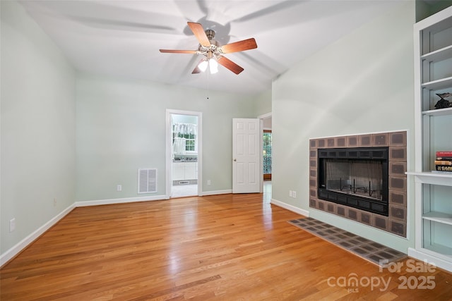 12 Woodvine Ln, Lake Wylie, SC 29710 - unfurnished living room with wood finished floors, ceiling fan, and a tile fireplace