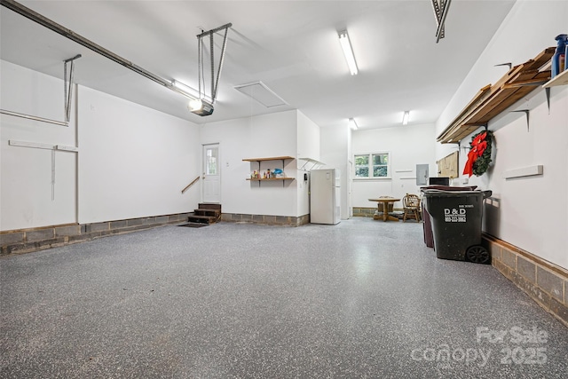 12 Woodvine Ln, Lake Wylie, SC 29710 - garage featuring a garage door opener, electric panel, and freestanding refrigerator