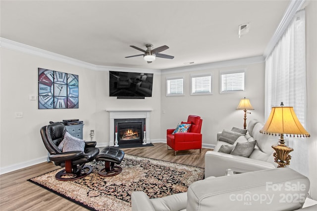 117 Cup Chase Dr, Mooresville, NC 28115 - living area featuring ornamental molding, a ceiling fan, wood finished floors, and a fireplace with flush hearth