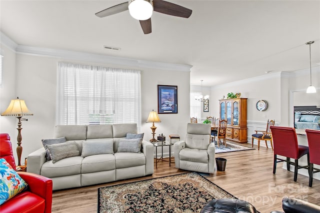 117 Cup Chase Dr, Mooresville, NC 28115 - living area featuring crown molding, wood finished floors, plenty of natural light, a chandelier, and a ceiling fan