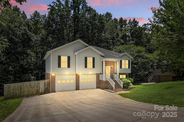 824 17th Avenue Dr SE, Hickory, NC 28602 - split foyer home with concrete driveway, an attached garage, and brick siding