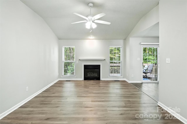 824 17th Avenue Dr SE, Hickory, NC 28602 - unfurnished living room with lofted ceiling, healthy amount of natural light, a glass covered fireplace, ceiling fan, and wood finished floors