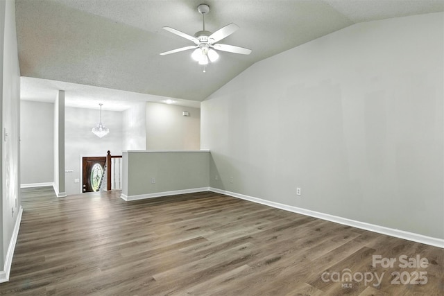 824 17th Avenue Dr SE, Hickory, NC 28602 - empty room with lofted ceiling, a ceiling fan, wood finished floors, and a chandelier