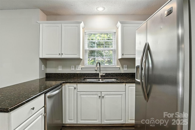 824 17th Avenue Dr SE, Hickory, NC 28602 - kitchen with stainless steel appliances, white cabinetry, a textured ceiling, and dark stone counters