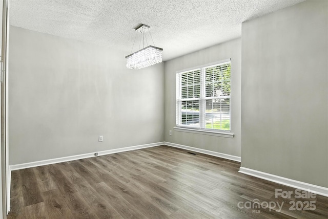 824 17th Avenue Dr SE, Hickory, NC 28602 - unfurnished dining area featuring a chandelier, a textured ceiling, and dark wood-style flooring
