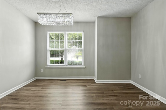 824 17th Avenue Dr SE, Hickory, NC 28602 - unfurnished dining area with a chandelier, a textured ceiling, and wood finished floors