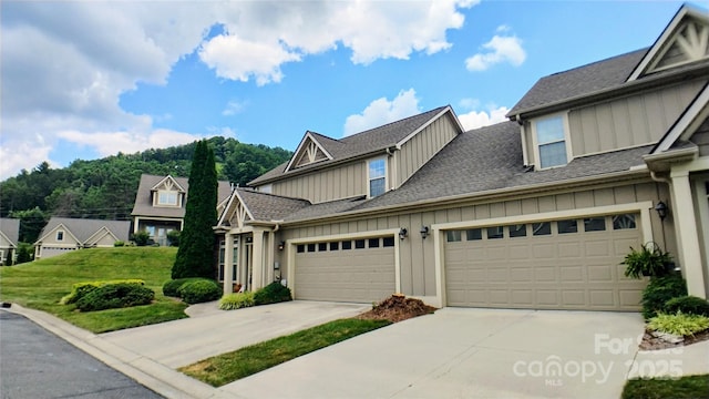 22 Florian Ln, Fletcher, NC 28732 - view of front of home with board and batten siding, concrete driveway, a shingled roof, and a garage