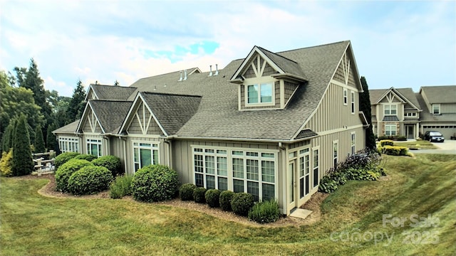 22 Florian Ln, Fletcher, NC 28732 - rear view of property featuring board and batten siding, a yard, and roof with shingles