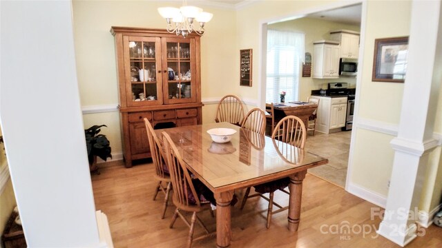 22 Florian Ln, Fletcher, NC 28732 - dining room featuring a chandelier, light wood-type flooring, and crown molding