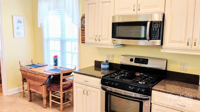 22 Florian Ln, Fletcher, NC 28732 - kitchen with appliances with stainless steel finishes, white cabinets, and light tile patterned flooring