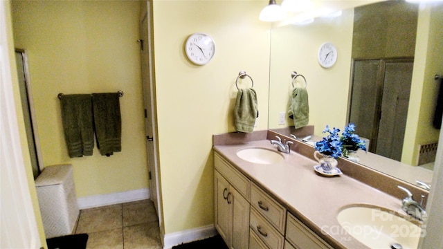 22 Florian Ln, Fletcher, NC 28732 - bathroom featuring double vanity, tile patterned flooring, and a shower with door