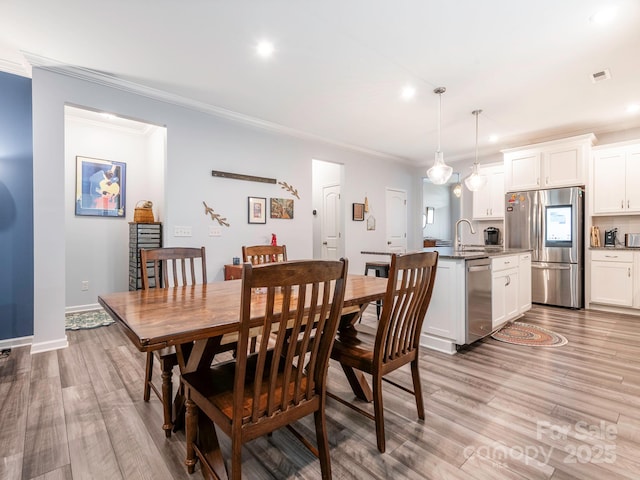 1711 Woodend Dr, Indian Trail, NC 28079 - dining area featuring crown molding, light wood-type flooring, and recessed lighting