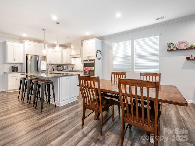 1711 Woodend Dr, Indian Trail, NC 28079 - dining space featuring ornamental molding, light wood-style floors, and recessed lighting