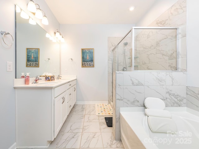 1711 Woodend Dr, Indian Trail, NC 28079 - bathroom with marble look tile flooring, a garden tub, double vanity, and a stall shower