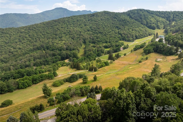 1648 Skyland Dr Unit 77, Seven Devils, NC 28604 - drone / aerial view of a forest and a mountainous background