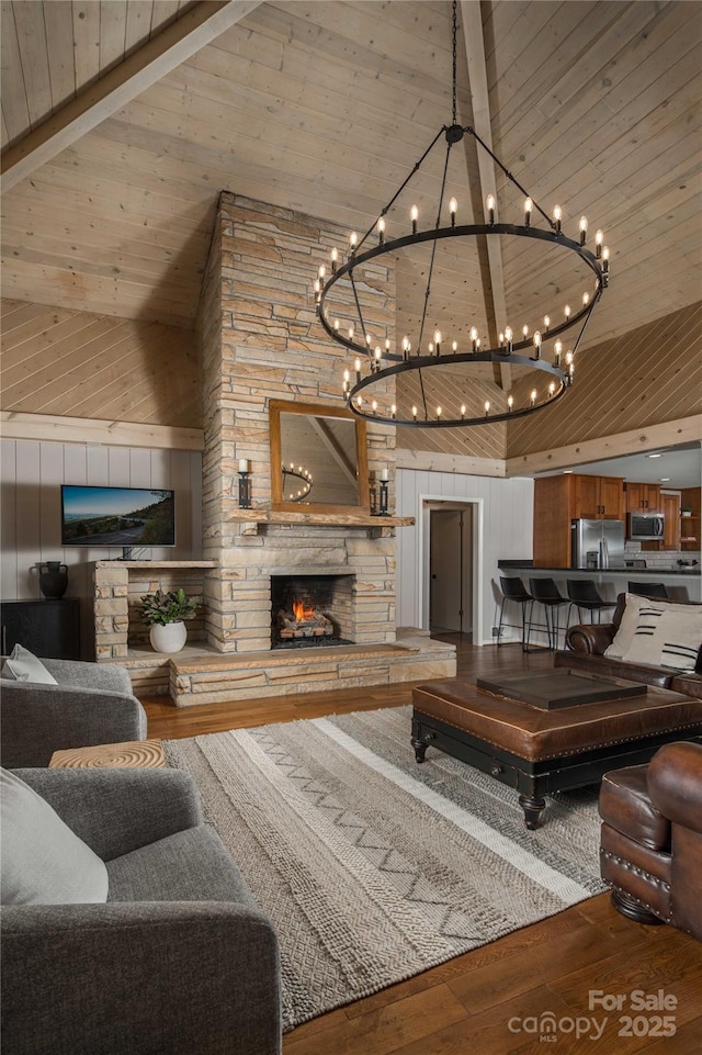 1648 Skyland Dr Unit 77, Seven Devils, NC 28604 - living area featuring high vaulted ceiling, hardwood / wood-style floors, wood walls, a wood ceiling with exposed beams, and a stone fireplace