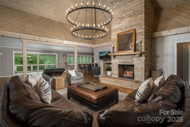 1648 Skyland Dr Unit 77, Seven Devils, NC 28604 - living room featuring high vaulted ceiling, a chandelier, wooden walls, a stone fireplace, and wood finished floors