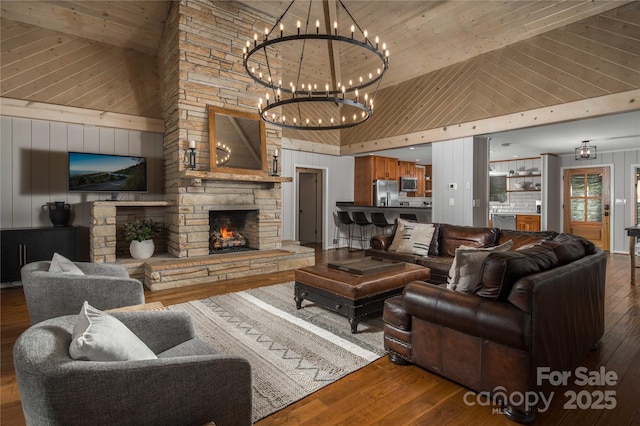 1648 Skyland Dr Unit 77, Seven Devils, NC 28604 - living room featuring high vaulted ceiling, hardwood / wood-style floors, wooden ceiling, a stone fireplace, and a chandelier