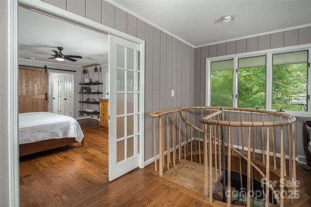 1648 Skyland Dr Unit 77, Seven Devils, NC 28604 - bedroom with crown molding, wood-type flooring, and wooden walls