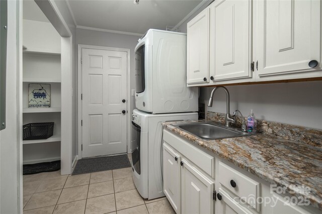 1648 Skyland Dr Unit 77, Seven Devils, NC 28604 - laundry area with stacked washing machine and dryer, cabinet space, ornamental molding, and light tile patterned floors