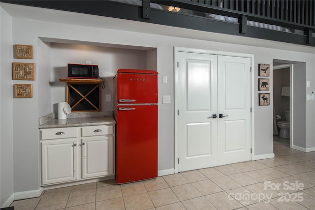 1648 Skyland Dr Unit 77, Seven Devils, NC 28604 - kitchen featuring fridge, white cabinetry, light tile patterned floors, and light countertops