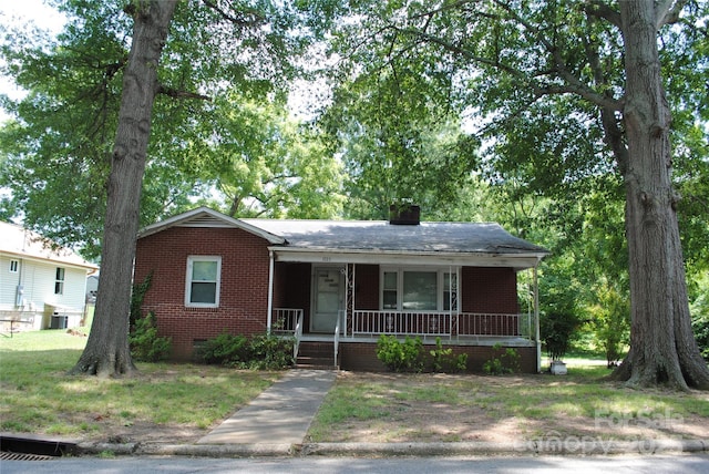 1125 Fries St, Salisbury, NC 28144 - view of front of house featuring brick siding, a porch, and a chimney