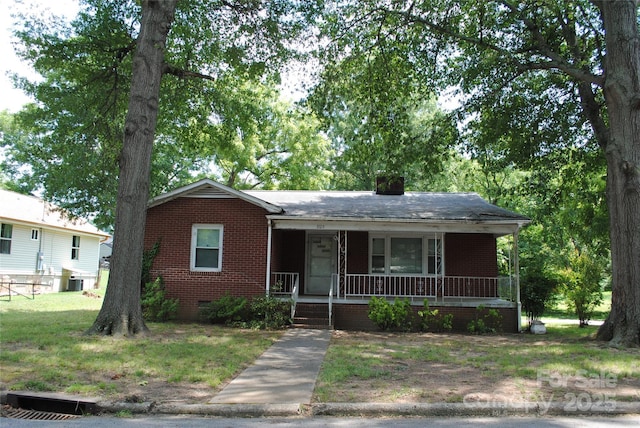 1125 Fries St, Salisbury, NC 28144 - view of front of house with brick siding, a porch, and a chimney