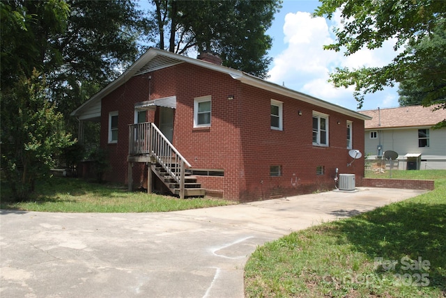 1125 Fries St, Salisbury, NC 28144 - view of side of property with brick siding, a chimney, and a lawn