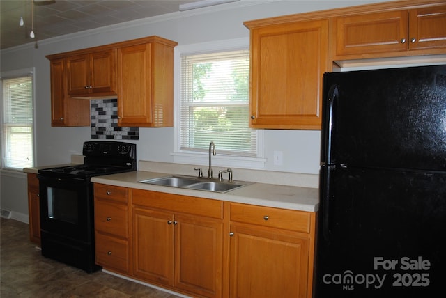 1125 Fries St, Salisbury, NC 28144 - kitchen featuring black appliances, light countertops, crown molding, and brown cabinets