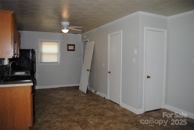 1125 Fries St, Salisbury, NC 28144 - kitchen with crown molding, ceiling fan, and brown cabinetry