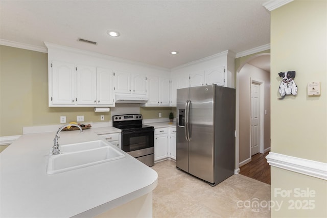 101 Citation Ln, Gastonia, NC 28056 - kitchen featuring stainless steel appliances, under cabinet range hood, arched walkways, crown molding, and light countertops