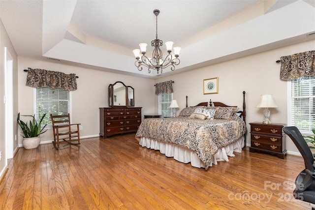 101 Citation Ln, Gastonia, NC 28056 - bedroom featuring a chandelier, wood-type flooring, and a raised ceiling