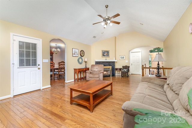 101 Citation Ln, Gastonia, NC 28056 - living area featuring arched walkways, light wood finished floors, ceiling fan, a tile fireplace, and a chandelier