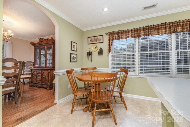 101 Citation Ln, Gastonia, NC 28056 - dining area with arched walkways, ornamental molding, and a chandelier