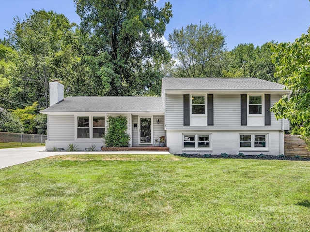 3200 Spring Valley Rd, Charlotte, NC 28210 - split level home with brick siding, a chimney, and roof with shingles