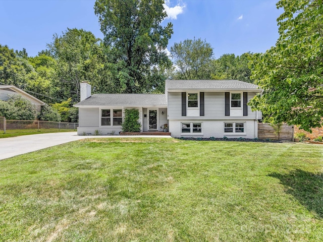 3200 Spring Valley Rd, Charlotte, NC 28210 - split level home featuring a chimney, concrete driveway, and a shingled roof
