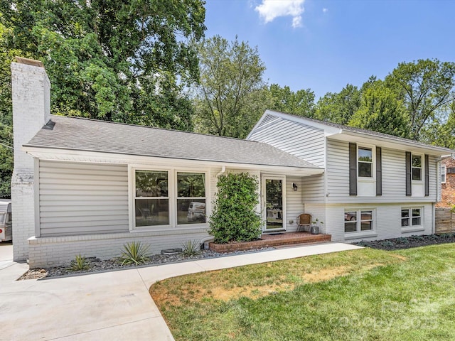 3200 Spring Valley Rd, Charlotte, NC 28210 - tri-level home with brick siding, a chimney, a front lawn, and a shingled roof