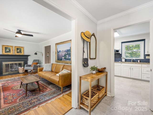 3200 Spring Valley Rd, Charlotte, NC 28210 - living area featuring ornamental molding, a ceiling fan, and a glass covered fireplace