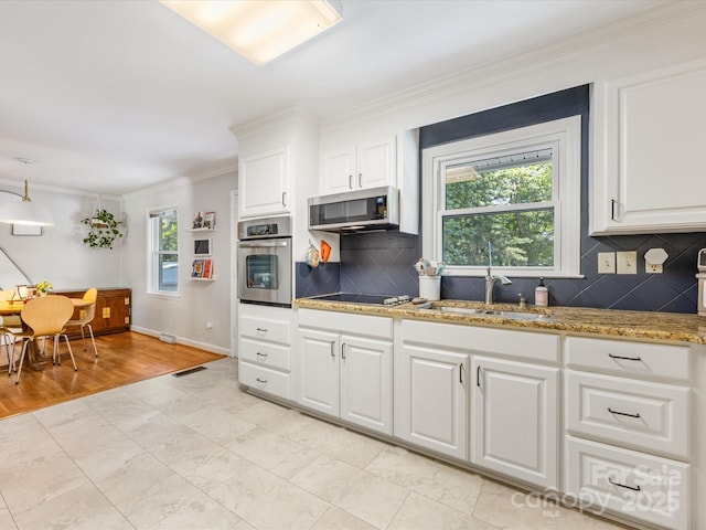 3200 Spring Valley Rd, Charlotte, NC 28210 - kitchen with stainless steel appliances, crown molding, tasteful backsplash, and white cabinetry