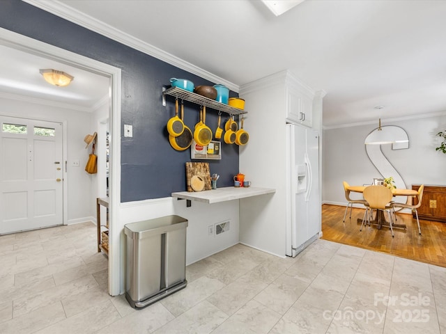 3200 Spring Valley Rd, Charlotte, NC 28210 - kitchen with white refrigerator with ice dispenser, crown molding, white cabinets, and light tile patterned floors